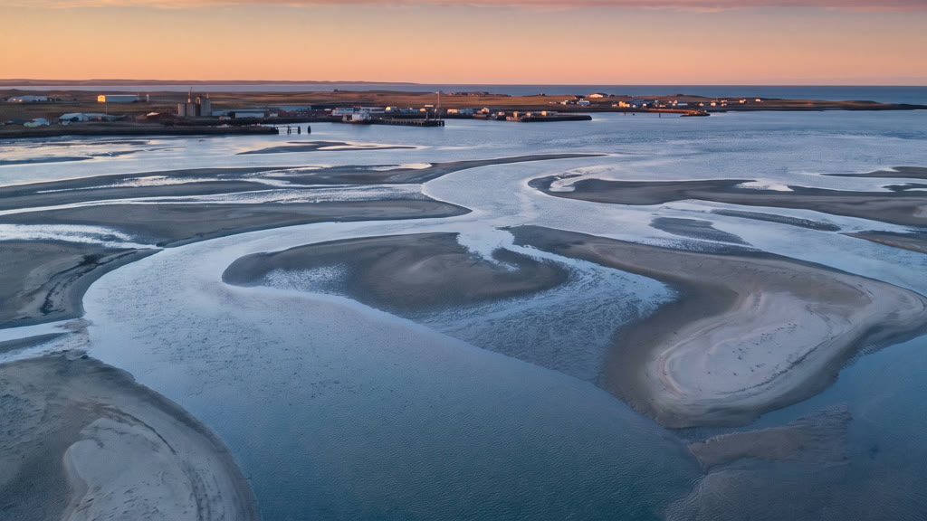 Winding tidal channels between sandbanks, seen from above at first light.