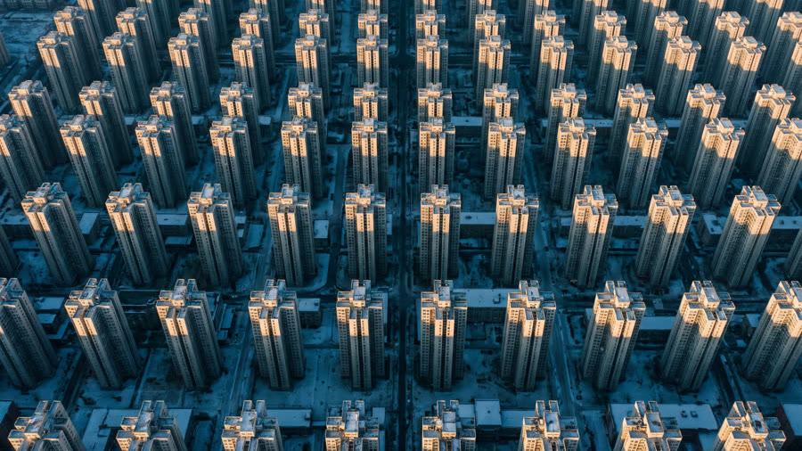 Rows of identical residential towers, seen from above.